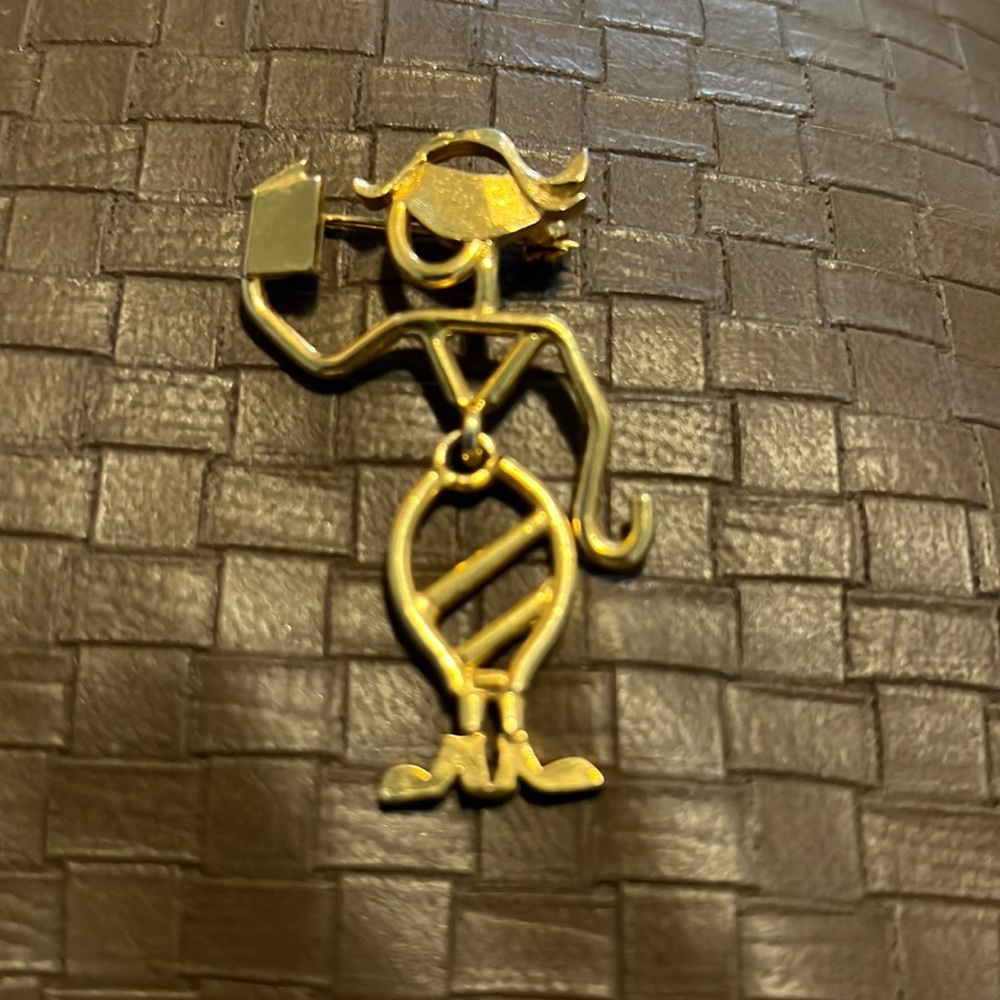 Gold colored brooch